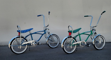Custom lowrider bicycle with chrome sissy bar, twisted frame inserts, and whitewall tires